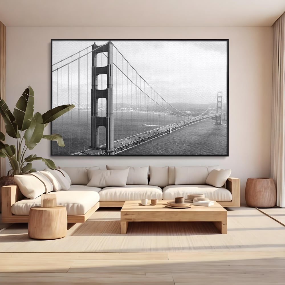 Tablou canvas cu fotografie alb-negru cu podul golden gate, in rama de aluminiu negru, pe perete intr-un living